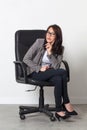 Young businesswoman posing in office chair for her startup job Royalty Free Stock Photo