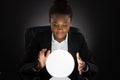 Young Businesswoman Predicting Future With Crystal Ball Royalty Free Stock Photo