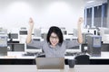 Young businesswoman raising hands on office Royalty Free Stock Photo