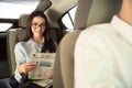 Young businesswoman reading newspaper in car Royalty Free Stock Photo