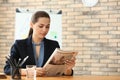 Young businesswoman reading newspaper in office Royalty Free Stock Photo