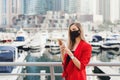 Young businesswoman in red suit and with blond hair wearing reusable protective face mask Royalty Free Stock Photo