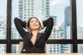 Young businesswoman relaxing at her desk in modern office Royalty Free Stock Photo