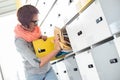 Young businesswoman removing file from locker at creative office