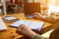 A young businesswoman is reviewing documents and their information to compile statistics and summarize annual results. The concept