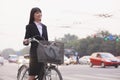 Young businesswoman riding a bicycle on the street, Beijing