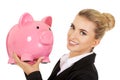 Young businesswoman saving money in piggybank
