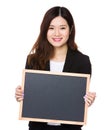 Young businesswoman showing with blank chalkboard Royalty Free Stock Photo