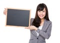 Young businesswoman showing the blank of chalkboard Royalty Free Stock Photo