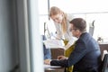 Young businesswoman showing book to businessman in meeting room Royalty Free Stock Photo