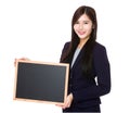 Young businesswoman showing empty chalkboard Royalty Free Stock Photo