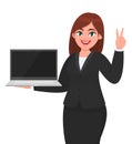 Young businesswoman showing a new brand laptop and making victory, V, peace or two gesture sign. Person holding portable computer. Royalty Free Stock Photo