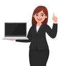 Young businesswoman showing a new brand laptop and pointing finger up. Person holding portable computer. Female character design. Royalty Free Stock Photo