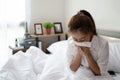 Young businesswoman is sick and coughs heavily on the bed in her room Royalty Free Stock Photo