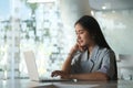 Young businesswoman sitting in bright modern office and using laptop computer Royalty Free Stock Photo