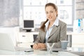 Young businesswoman sitting in bright office Royalty Free Stock Photo