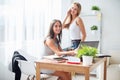 Young businesswoman sitting at desk front laptop computer with her coleague. Coffee break office Royalty Free Stock Photo