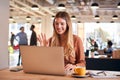 Young Businesswoman Sitting At Desk On Video Call In Modern Open Plan Office Royalty Free Stock Photo