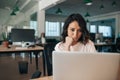 Young businesswoman sitting at her desk working on a laptop Royalty Free Stock Photo