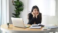 Young businesswoman sitting at her modern workplace and smiling to camera. Royalty Free Stock Photo
