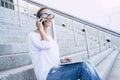 Young businesswoman sitting outdoor with laptop and phone calling and working free in remote smart office - modern people and Royalty Free Stock Photo