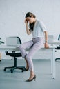 young businesswoman sitting on table and suffering from headache Royalty Free Stock Photo