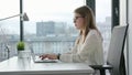 Bisinesswoman Sitting and Using a Laptop Indoors