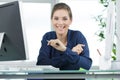 Young businesswoman smiling while working at glass desk