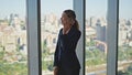 Young businesswoman speaking cellphone in modern office. Smiling worker resting Royalty Free Stock Photo