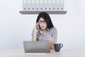 Young businesswoman with damaged laptop