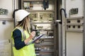 Young businesswoman standing in front of the control panel in the control room Royalty Free Stock Photo