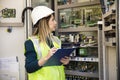 Young businesswoman standing in front of the control panel in the control room Royalty Free Stock Photo