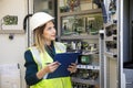 Young businesswoman standing in front of the control panel in the control room Royalty Free Stock Photo