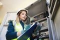 Young businesswoman standing in front of the control panel in the control room Royalty Free Stock Photo