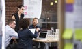 Young Businesswoman Standing And Leading Office Meeting Around Table Royalty Free Stock Photo