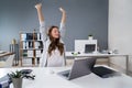Businesswoman Stretching At Desk Royalty Free Stock Photo