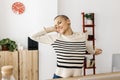 Young businesswoman stretching at home office workplace