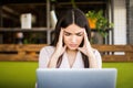 Young businesswoman suffering from headache in front of laptop at office Royalty Free Stock Photo