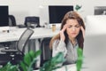 Young businesswoman suffering from headache while working