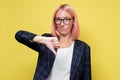 Young businesswoman in suit and glasses showing thumb down Royalty Free Stock Photo