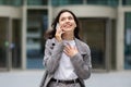 Young businesswoman in suit happily talking on her phone outside Royalty Free Stock Photo