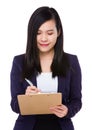 Young businesswoman take note on clipboard Royalty Free Stock Photo