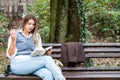 Young businesswoman taking a break from work sitting in the park relaxing while reading a book. Business female office worker read Royalty Free Stock Photo