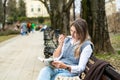 Young businesswoman taking a break from work sitting in the park relaxing while reading a book. Business female office worker read Royalty Free Stock Photo