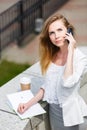 Young businesswoman talking on cellphone while walking outdoor Royalty Free Stock Photo