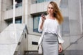 Young businesswoman talking on cellphone while walking outdoor Royalty Free Stock Photo