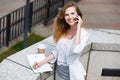 Young businesswoman talking on cellphone while walking outdoor Royalty Free Stock Photo