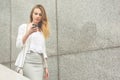 Young businesswoman talking on cellphone while walking outdoor Royalty Free Stock Photo