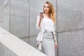 Young businesswoman talking on cellphone while walking outdoor Royalty Free Stock Photo