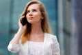 Young businesswoman talking on cellphone while walking outdoor Royalty Free Stock Photo